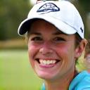 Headshot of Sarah, a golfer smiling after a great shot.